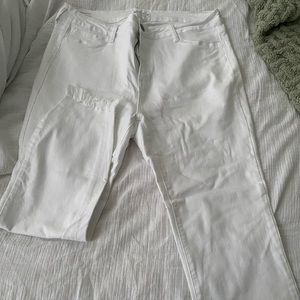 White jeans with fringe at ankle